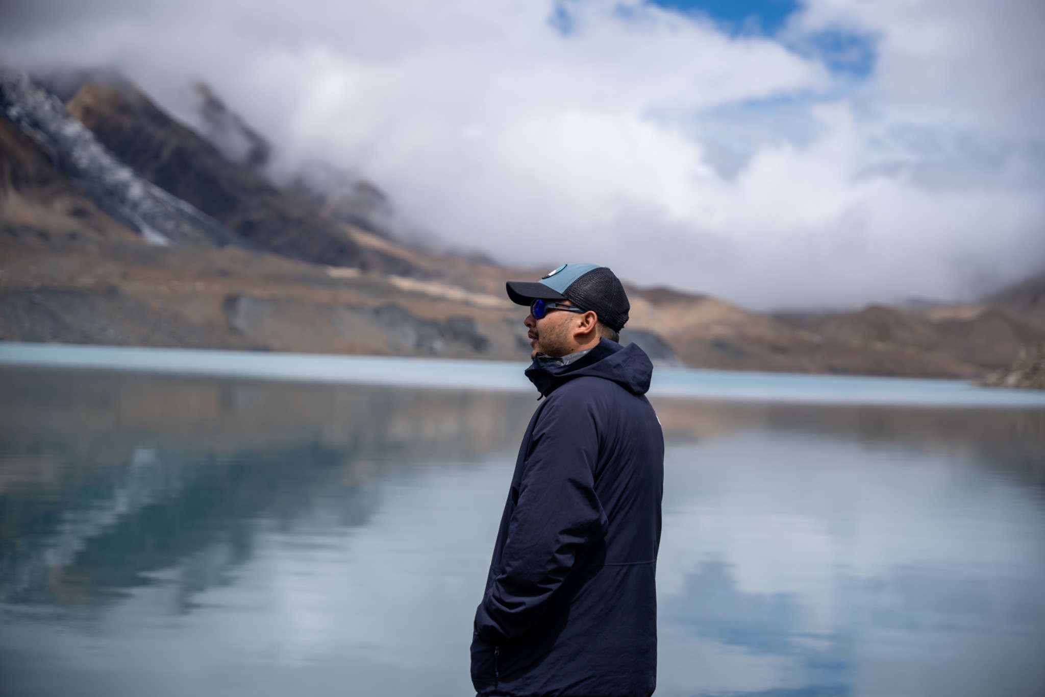 Subesh Shrestha standing beside a mountain lake