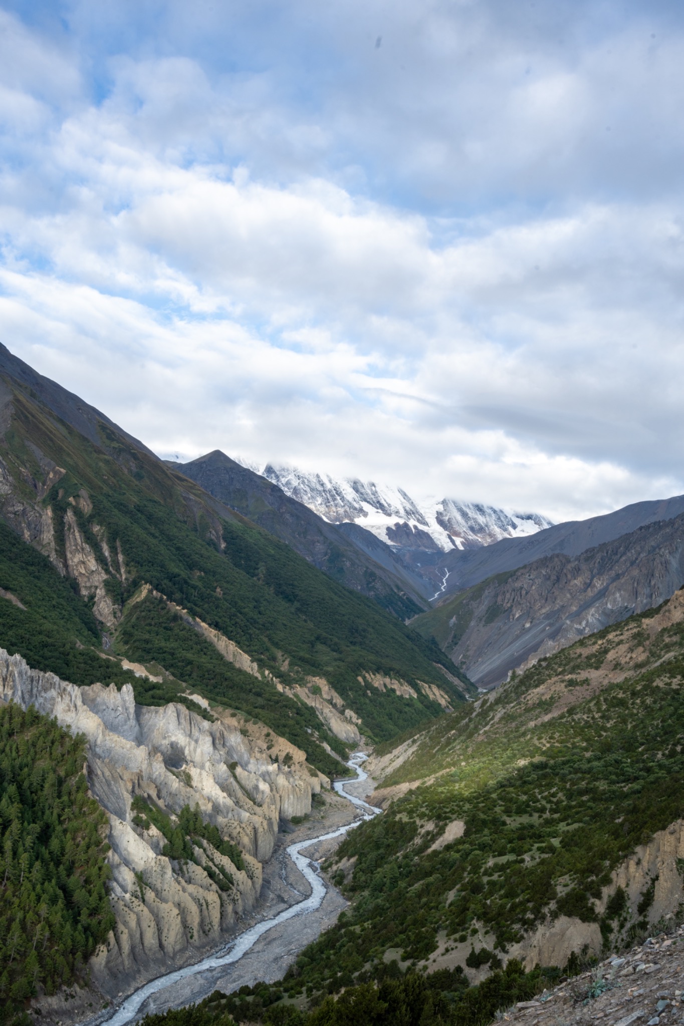 A river winding through a steep green mountain valley