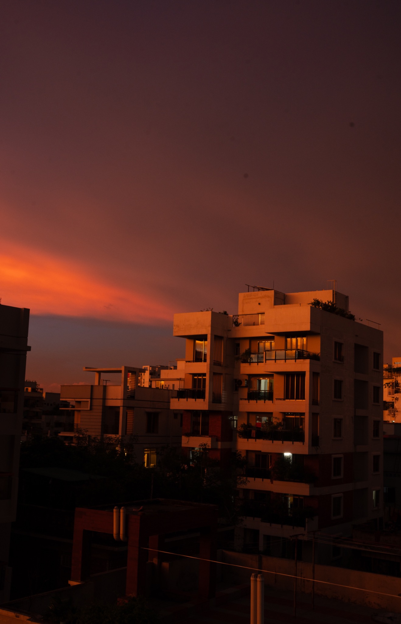 Warm red sunset light falling across city rooftops